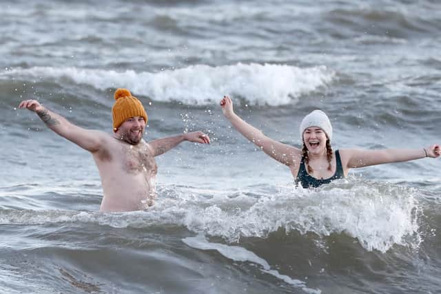 Brother and sister Matthew and Rachael Morrison from Bangor bathing on Helens Bay Beach on New Years Day. Photo: Declan Roughan / Press Eye.