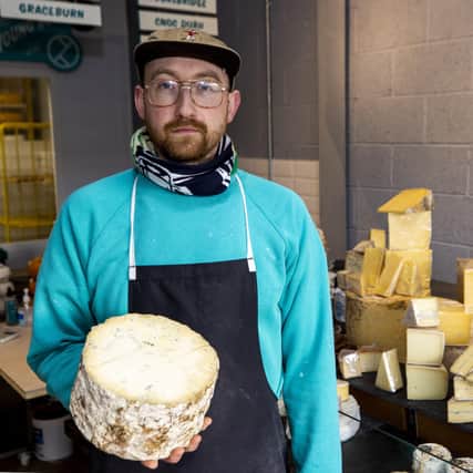 Michael Thomson of Mike's Fancy Cheese in Belfast holding half a truckle of Young buck, a raw milk blue cheese made in Newtownards.