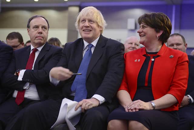Boris Johnson, flanked by Nigel Dodds and Arlene Foster, at the DUP conference in 2018