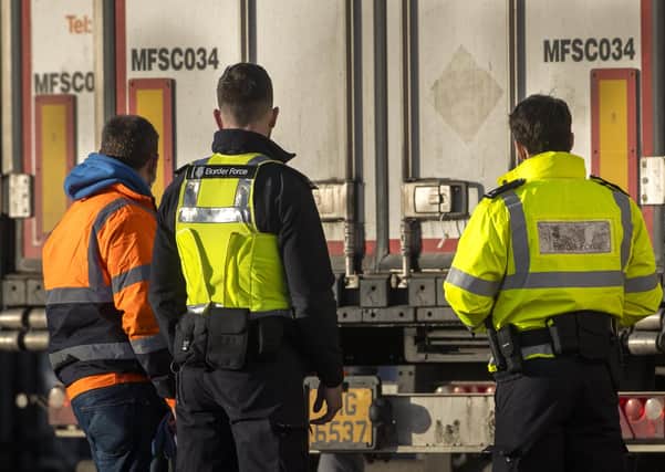 Border Force officials talk to a lorry driver at the DEARA site near Belfast Harbour for inspections, as the UK leaves the single market and customs union and the Brexit transition period comes to an end