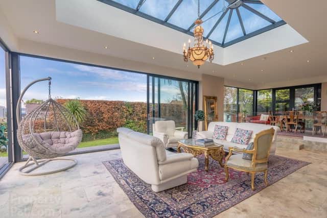 The property has a contemporary Sunroom with Triple Glazed Windows & Sliding Doors to Patio Entertainment Area