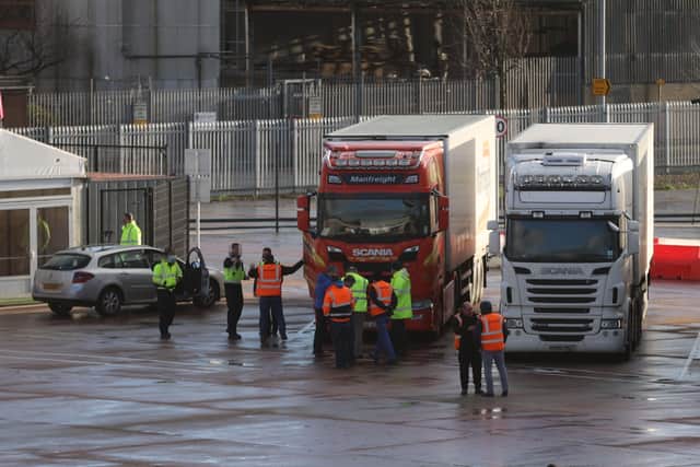 Lorry drivers and officials talk at the DEARA site near Belfast Port, as the UK leaves the single market and customs union and the Brexit transition period comes to an end.