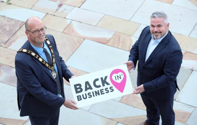 Mayor of Antrim and Newtownabbey, Councillor Jim Montgomery is joined by Gerry McKibbin, Department for Communities to promote almost £1 million funding for businesses across the retail and tourism sectors of the Borough.