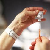 The Oxford/AstraZeneca Covid-19 vaccine is loaded into a syringe before being administered to a patient at Falls Surgery on the Falls Road, Belfast.