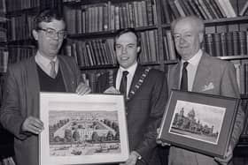 Linen Hall librarian John Gray, left, presenting a print of the White Linen Hall, Belfast, to the Lord Mayor of Belfast Nigel Dodds in December 1988. The White Hall was demolished to make way for the City Hall. The First Citizen was on a visit to the historic library to hand over as a reciprocal gesture a Charter centenary commemorative picture of the civic citadel. With him was town clerk Cecil Ward. Picture: News Letter archives