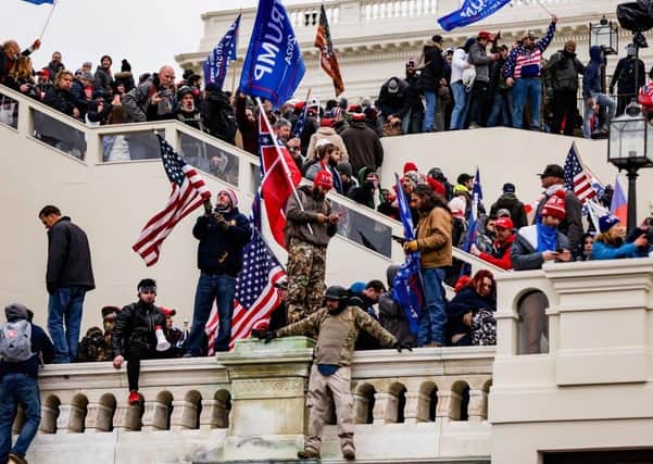 Trump supporters storm the US Capitol building after a rally by the president on January 6. Michael Palmer says: "Even if one accepts Trump did not intend for the riots to happen, he did not turn down their rhetoric when he saw his supporters enraged"
