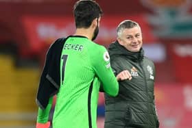 Liverpool goalkeeper Alisson greets Manchester United manager Ole Gunnar Solskjaer after the final whistle. Pic by PA.
