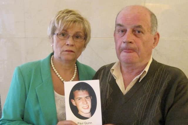 Breege Quinn and Stephen Quinn, hold a photo of their murdered son Paul.
