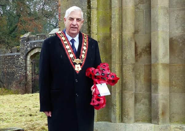 Rev William Anderson lays a wreath in memory of Sir Norman Stronge at the entrance to Tynan Abbey