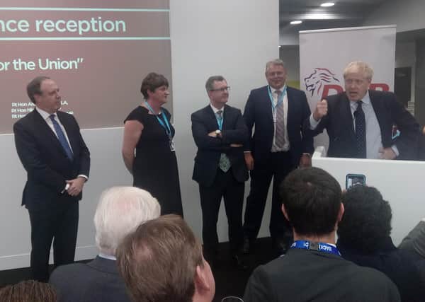 Nigel Dodds MP, Arlene Foster MLA and Sir Jeffrey Donaldson MP listen to the prime minister, Boris Johnson, addressing the DUP drinks reception at the Conservative Party conference October 1 2019. The following day the DUP agreed to a regulatory border in the Irish Sea (but it says it only did so subject to a Stormont veto)
