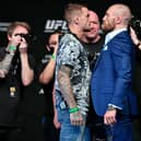 Dustin Poirier (left) and Conor McGregor face off for media during the UFC 257 press conference event inside Etihad Arena on UFC Fight Island on January 21, 2021 in Yas Island, Abu Dhabi, United Arab Emirates. (Photo by Jeff Bottari/Zuffa LLC via Getty Images).