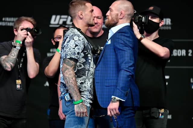 Dustin Poirier (left) and Conor McGregor face off for media during the UFC 257 press conference event inside Etihad Arena on UFC Fight Island on January 21, 2021 in Yas Island, Abu Dhabi, United Arab Emirates. (Photo by Jeff Bottari/Zuffa LLC via Getty Images).