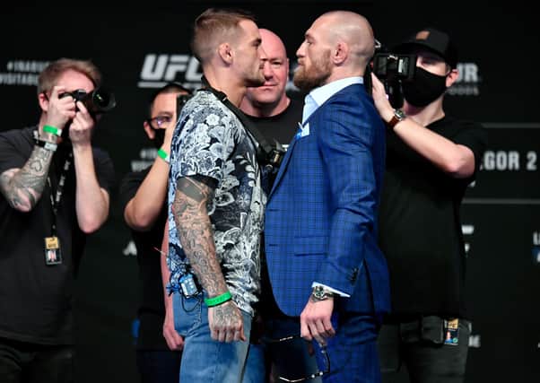 Dustin Poirier (left) and Conor McGregor face off for media during the UFC 257 press conference event inside Etihad Arena on UFC Fight Island on January 21, 2021 in Yas Island, Abu Dhabi, United Arab Emirates. (Photo by Jeff Bottari/Zuffa LLC via Getty Images).