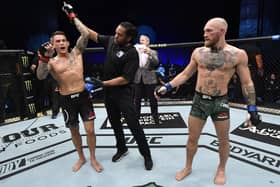 Dustin Poirier reacts after his knockout victory over Conor McGregor of Ireland in a lightweight fight during the UFC 257 event inside Etihad Arena on UFC Fight Island on January 23, 2021 in Abu Dhab. (Photo by Jeff Bottari/Zuffa LLC via Getty Images).