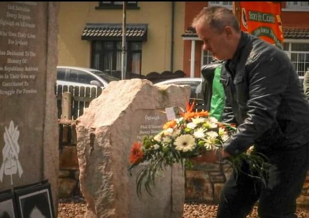 Eamonn McCourt laying a wreath at an IRA memorial