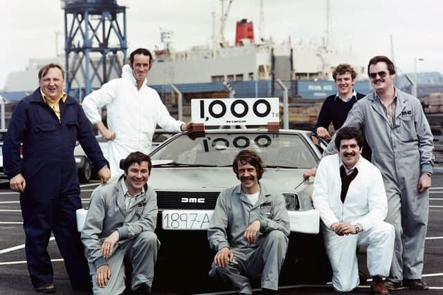 DeLorean employees pose with the 1,000th car to be shipped to the USA before loading onto the Pearl Ace at Belfast docks, 1981