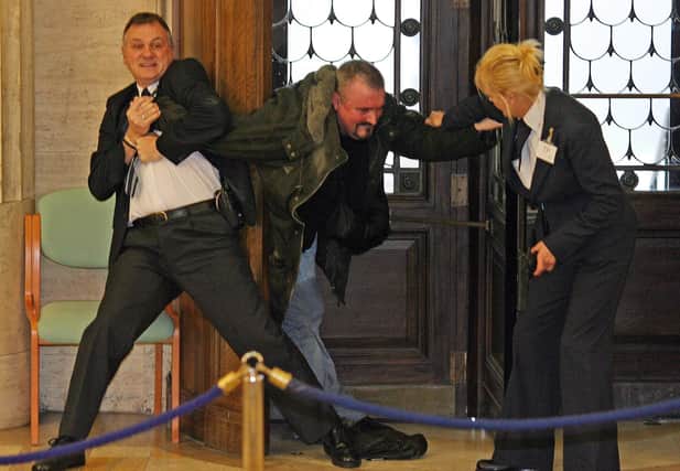 Michael Stone being restrained at Stormont
