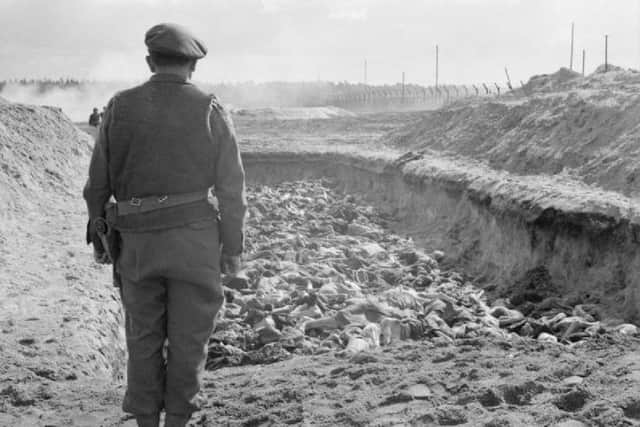 British Army Chaplain at a massed grave at Bergen-Belsen Concentration Camp after liberation in April 1945. Photo Imperial War Museum.