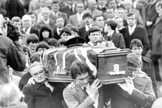The coffiin of RUC Reserve Constable William James Clements is carried from the lane of the family home outside Ballygawley, towards Ballynanny Methodist church in December 1985. Pic sent in by his son Rev David Clements, who is on the right of the picture, carrying the coffin, wearing glasses, his brother Alan is also carrying the coffing at the front, and at the back is their uncle, Rev Sam Clements, brother of the deceased