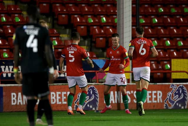 Walsall's Rory Holden (second right) celebrates scoring his side's first goal of the game with his teammates during the Sky Bet League Two match against Leyton Orient at Banks's Stadium.