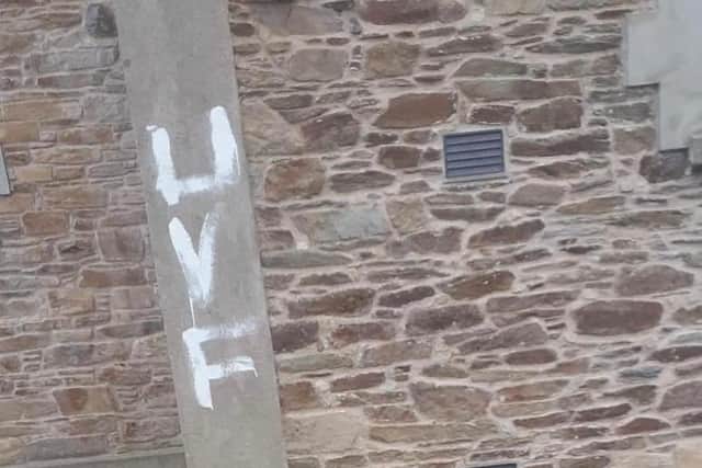Handout photo issued by the DUP of sectarian graffiti daubed on the walls of St Mary's church in Limavady, in Co Londonderry