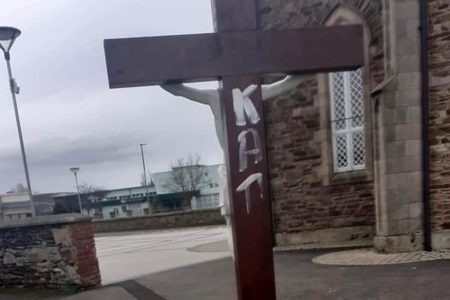 Handout photo issued by the DUP of sectarian graffiti daubed on the walls of St Mary's church in Limavady, in Co Londonderry