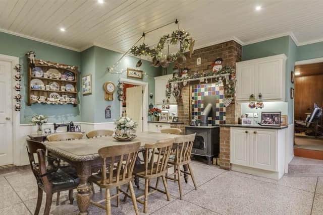 The house has a kitchen with casual dining, as well as a separate utility room and pantry