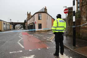 The scene on Portland Street in Kilmarnock, Ayrshire, where a 24-year-old woman was stabbed and later died in hospital. A 39-year old woman was also killed and a man died in a car crash in three incidents police believe are linked in the Kilmarnock area