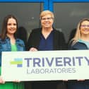 Triverity Laboratories founding members outside their European headquarters in Northern Ireland are Alix Britton, Director of Commercial Operations, Wendi Young, President and CEO, and Heather Krebs, Director of Laboratory Operations