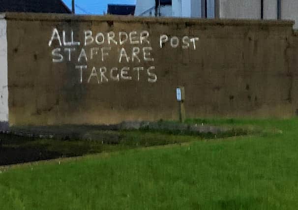 Threatening graffiti daubed on a wall in the harbour area of Larne