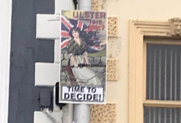 Controversial posters have appeared in Lurgan and Portadown, including outside Sinn Fein Upper Bann MLA John O'Dowd's office.