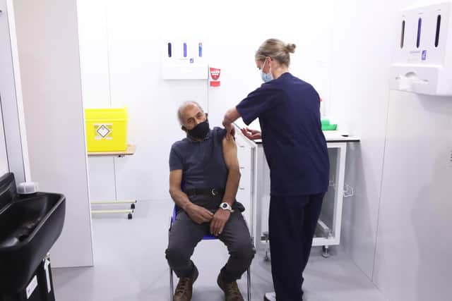 A man get his first dose of the Oxford/AstraZeneca vaccine on Monday.