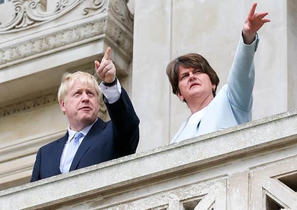 Arlene Foster, seen with Boris Johnson at Stormont in July 2019 weeks before he agreed the Irish Sea border, has merely said she will "keep the pressure" on him over the new barrier. Picture Matt Mackey / Press Eye