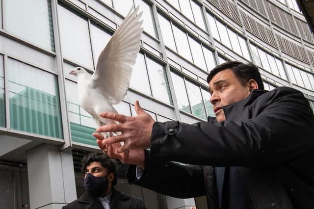 Docklands Victims Association president Jonathan Ganesh releases a dove during the 25th anniversary memorial service