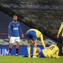 Rangers striker Kemar Roofe (centre) is booked for the challenge on Murray Davidson that has resulted in an SFA charge