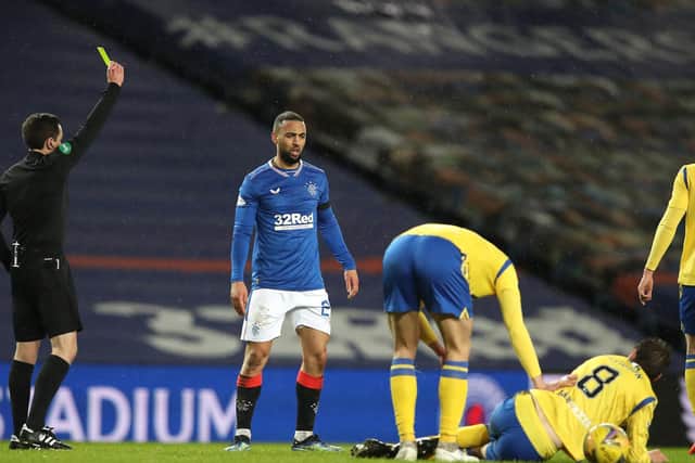 Rangers striker Kemar Roofe (centre) is booked for the challenge on Murray Davidson that has resulted in an SFA charge