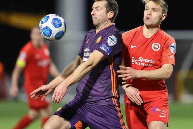 Portadown’s Stephen Murray and Larne’s Graham Kelly battle for the ball