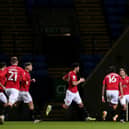 Brad Lyons (right) celebrates with his Morecambe team mates after equalising against Bolton