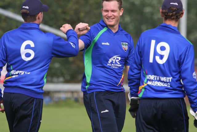 North West Warriors Graham Hume celebrates taking a wicket with William Porterfield (No 6) and William Smale (No 19). Picture by Barry Chambers