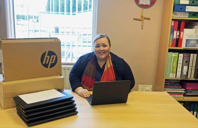 St Ronan’s College principal Fiona Kane with some of the laptops at the school in Lurgan