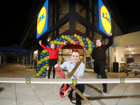 Pictured at the store opening are Lily Irvine (Edenbrooke Primary School), Thomas McFarlane (Lidl Northern Ireland Hillview Retail Park Store Manager) and Pearse Osborne (Holy Cross Boys Primary)