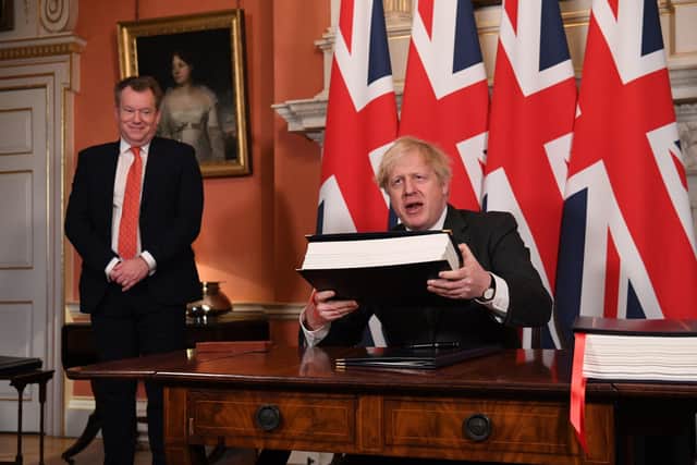 The then UK chief trade negotiator David (Lord) Frost as Boris Johnson signs the EU-UK deal on December 30. Lord Frost, who has been elevated to the cabinet, should be unleased to find a fair solution that is fair to the law abiding people of Northern Ireland. Photo: Leon Neal/PA Wire