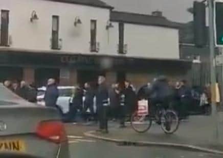 The PSNI said it is examining video footage which appears to relate to a funeral procession on the Falls Road this week.