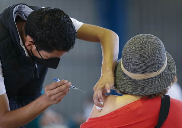 A healthcare worker administers a coronavirus vaccination