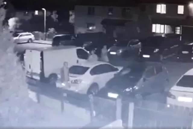 Still of video footage showing three men attacking cars outside a Portadown home.
