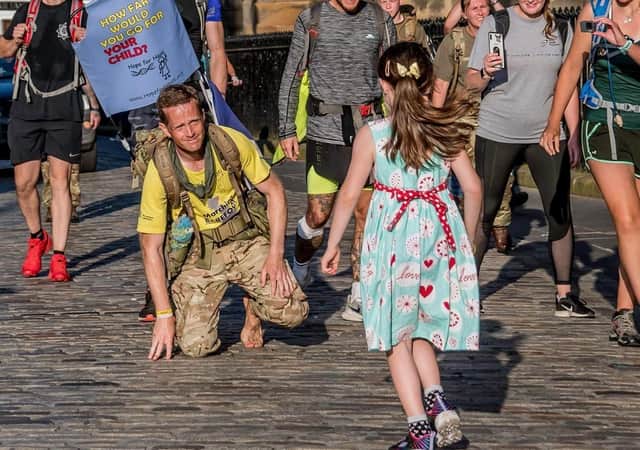Co Down-born army major Chris Brannigan being greeted by daughter Hasti in Edinburgh at the end of his 700-mile barefoot trek from Land's End in Cornwall last August