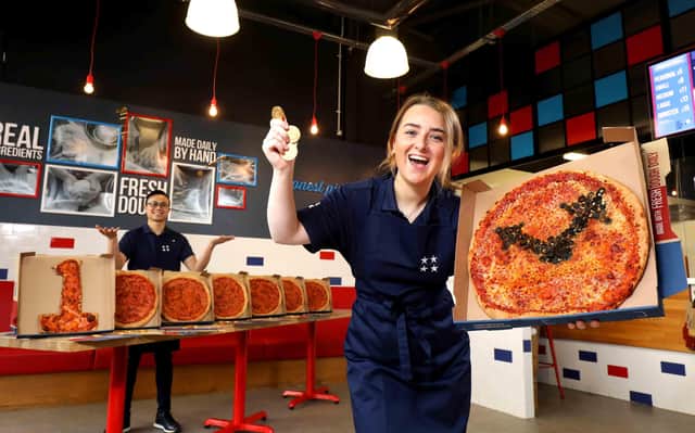 Ellie McBrierty and Kevin Yeung, Four Star Pizza, are hoping to deliver an unclaimed EuroMillions UK Millionaire Maker prize of £1,000,000 to a missing winner, who bought their ticket in Belfast
