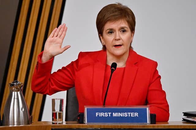 Scottish First Minister Nicola Sturgeon taking oath before giving evidence at Holyrood in Edinburgh