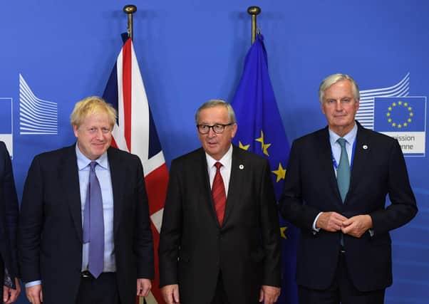 Prime Minister Boris Johnson, Jean-Claude Juncker, then President of the European Commission, and Michel Barnier, the EU Brexit negotiator, on October 17 2019 after Mr Johnson agreed an Irish Sea border with them. Richard Garland says: "Mr Johnson sold us out, but the EU have shown disdain for unionist concerns from the start of negotiations"