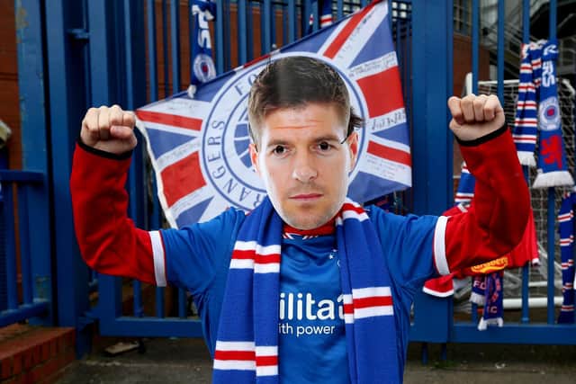 A Rangers fan wears a Steven Gerrard mask outside of the Ibrox Stadium